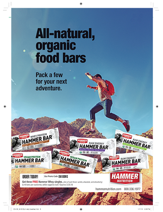 Ad for Hammer Nutrition showing girl jumping boulders in dessert above scattered Hammer Bars